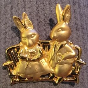 Vintage goldtone brooch pin features a charming couple of bunny rabbit icons